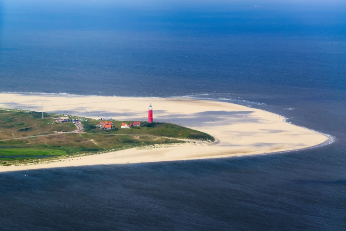 aerial photo of red and white lighthouse on seashore texel beach 2k 4k 5k