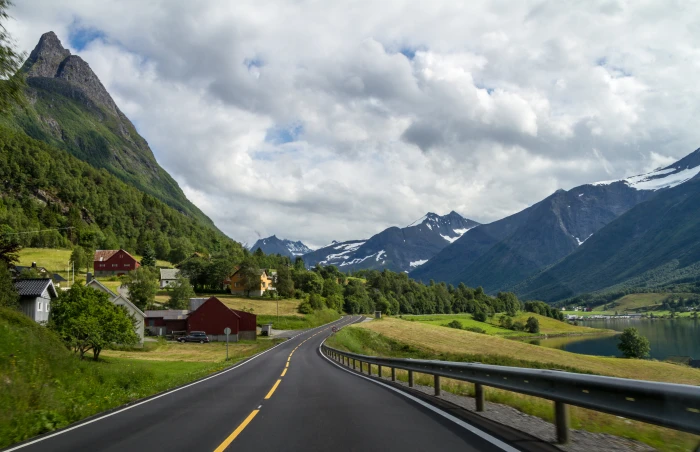 black top road across rocky mountains under white sky during daytime sykkylven 2k 4k 5k