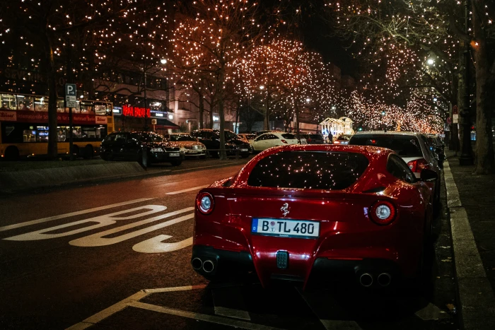red Ferrari coupe rear view night city scenery car street 2k 4k