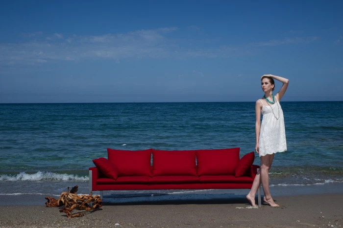 woman in white spaghetti strap mini dress standing beside red couch 2k 4k 5k