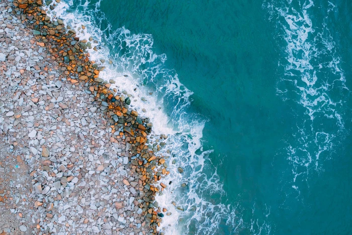 Aerial View Photography of Rocky Shore bird s eye view coast 2k 4k