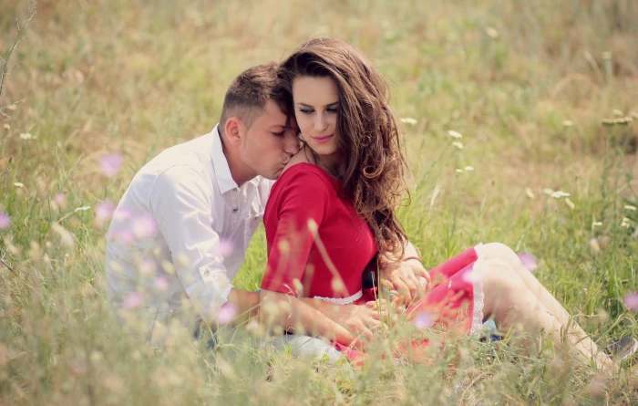 man and woman sitting on grass field during daytime couple love 2k 4k