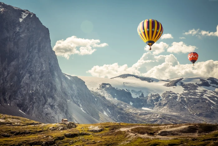 two yellow and red hot air balloons clouds snow cliff nature 2k 4k 5k