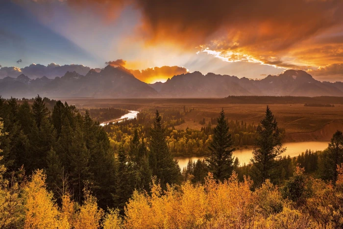 landscape photo of trees near river and mountain Explosion jackson hole 2k 4k 5k