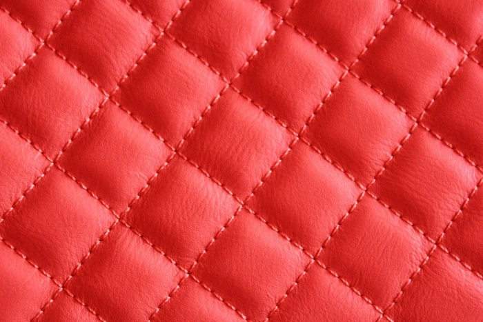 quilted red leather textile background triangles 2k