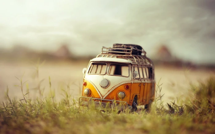 orange and white Volkswagen Kombi die cast toy macro background 2k