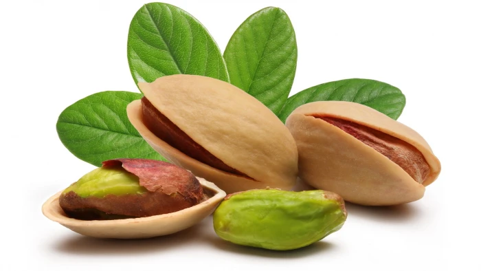 three brown pistachio nuts pistachios shell macro leaves 2k