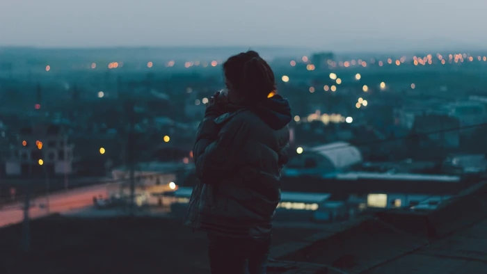 black bubble jacket with hood woman in and gray standing on a hill 2k