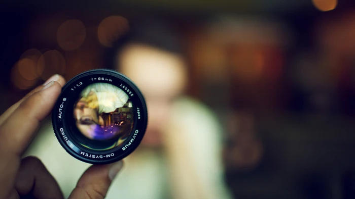 black camera lens blurred bokeh Olympus hands human body part 2k