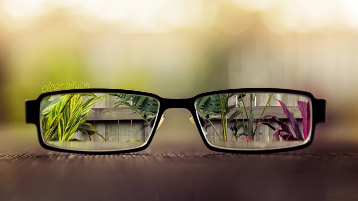 black framed eyeglasses bokeh close up no people table indoors 2k