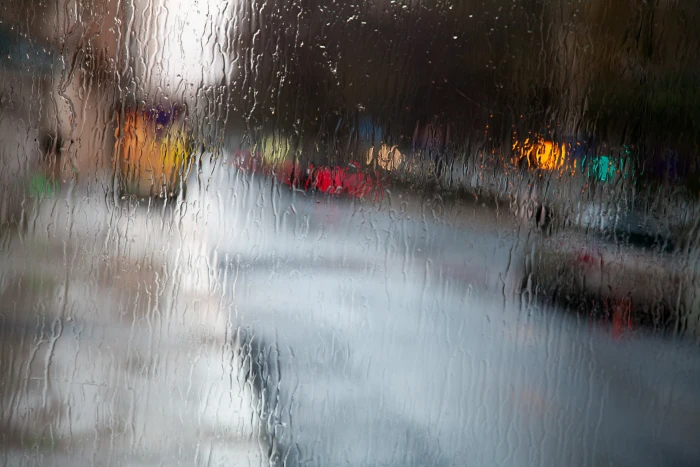 glass with water across cars on roads mood rain Portugal Lisbon 2k