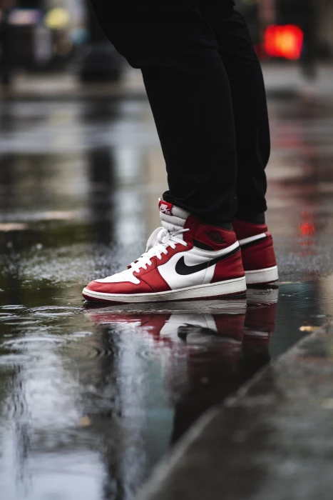 selective focus photography of person wearing white red and black Air Jordan 1 s Chicago 2k 4k