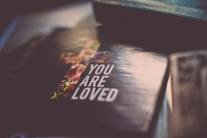 selective focus photography of You Are Loved book cover bokeh 2k 4k 5k