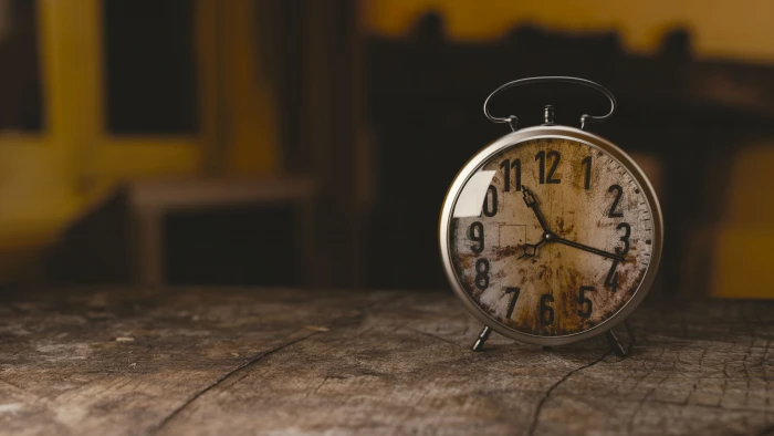 white alarm clock on top of gray wooden table round silver 2k 4k