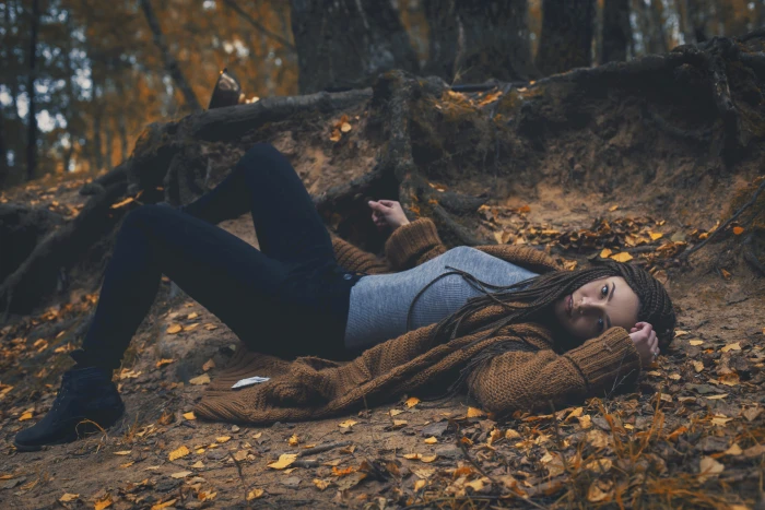 woman wearing brown cardigan and gray t shirt with black sweatpants laying in forest during daytime 2k 4k 5k
