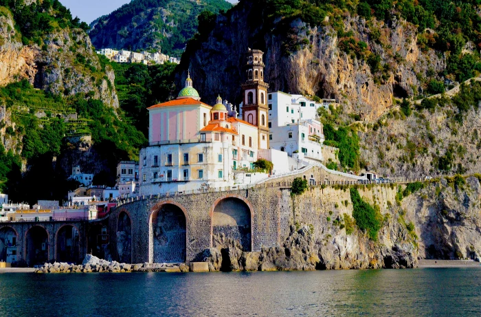 white and brown concrete building beside body of water during daytime 2k 4k 5k