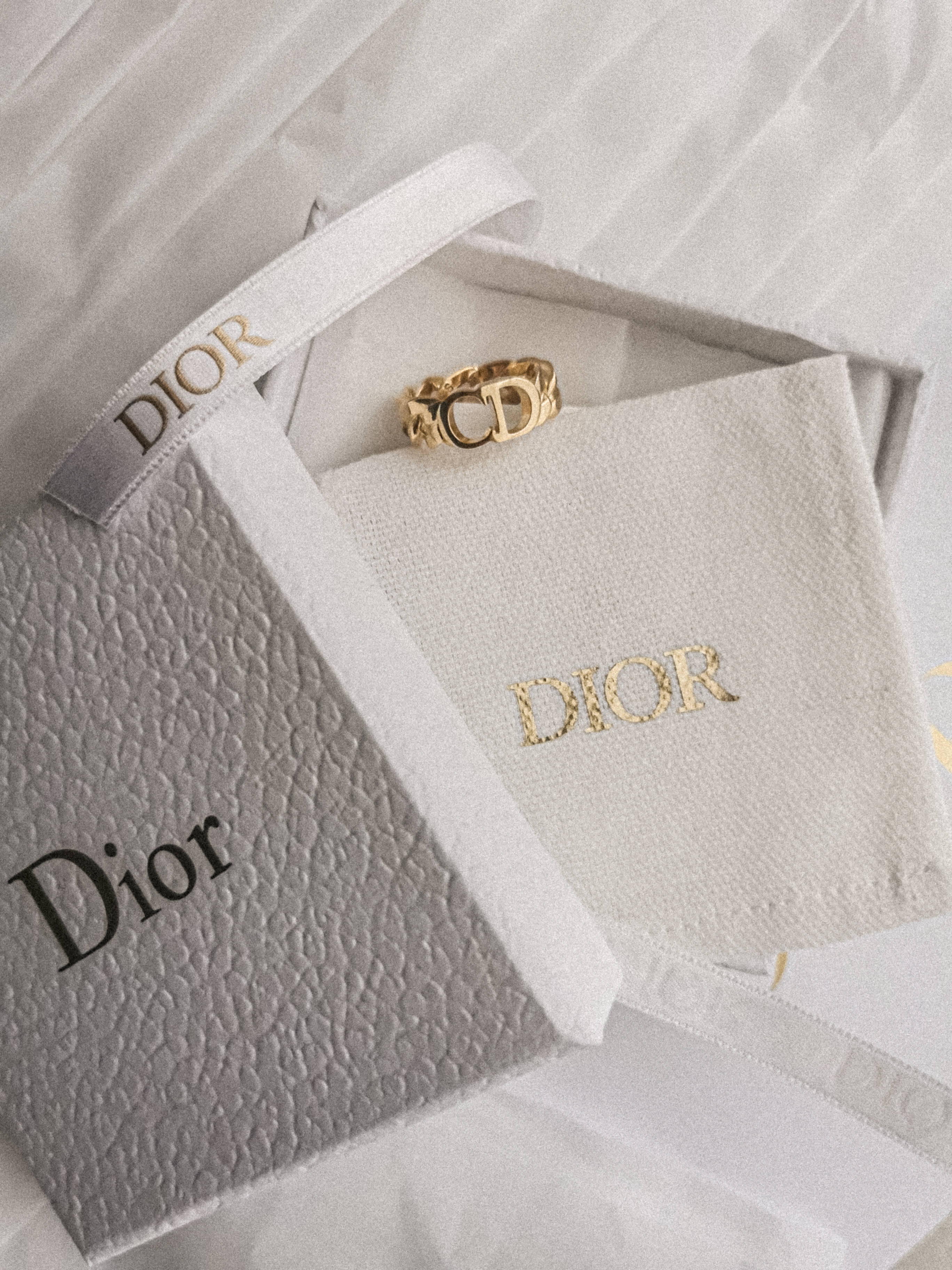 dior gold ring and gift box actress hollywood 2k