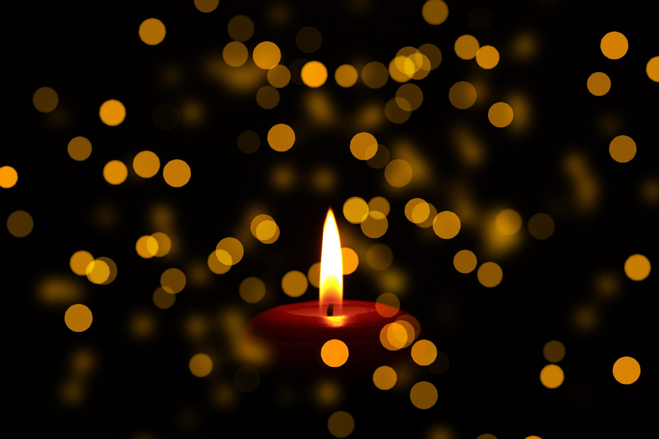 close up photo of lighted red candle bokeh photography mourning 2k