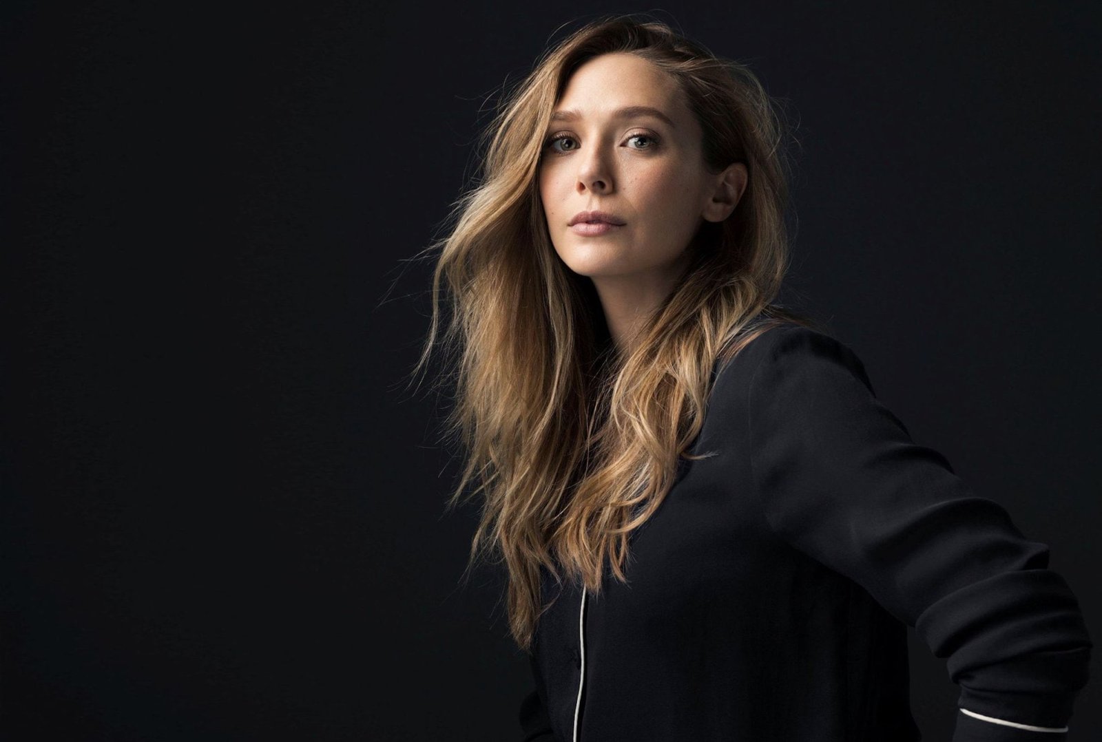 Actresses Elizabeth Olsen long hair studio shot black background