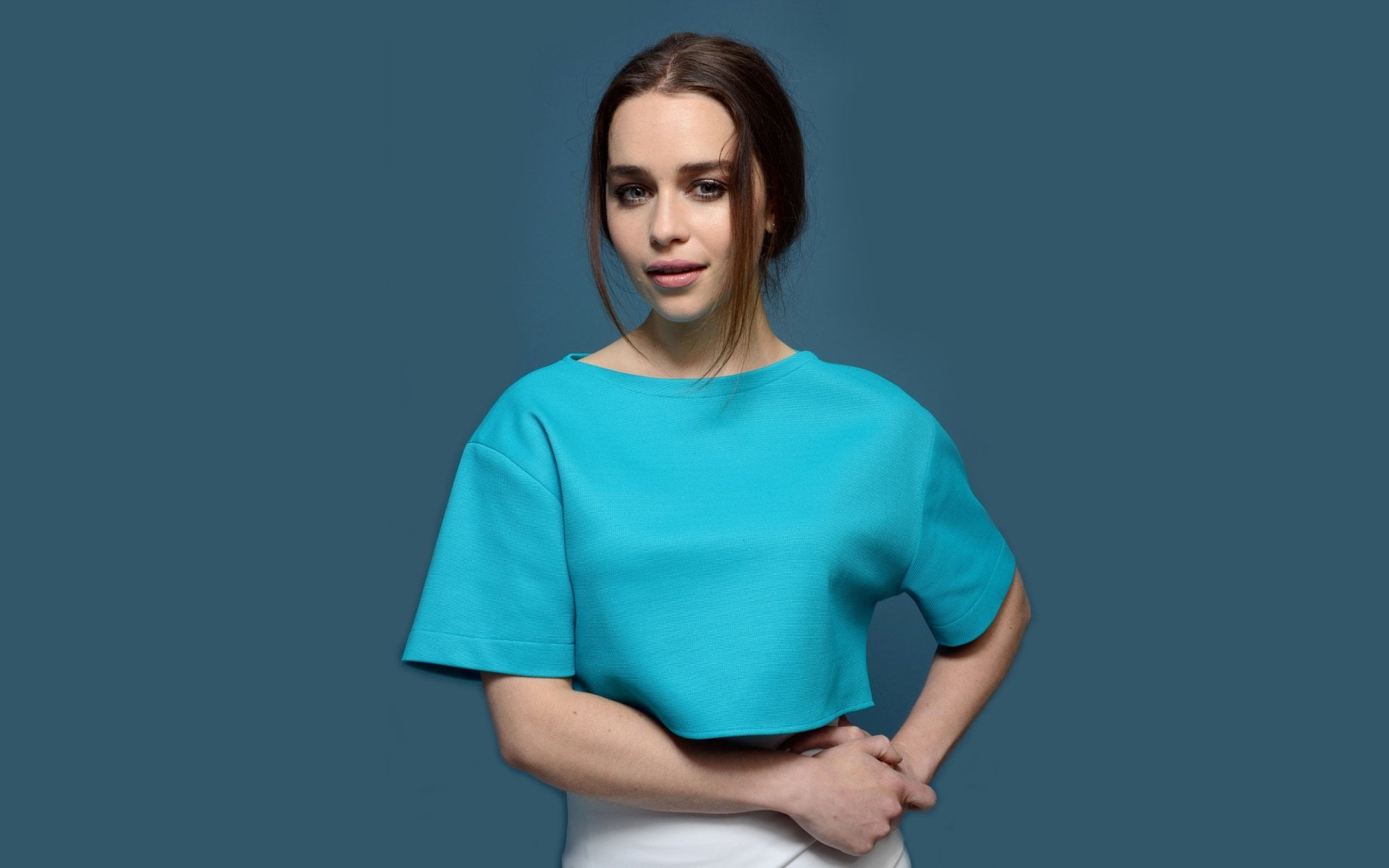 Actresses Emilia Clarke studio shot blue colored background
