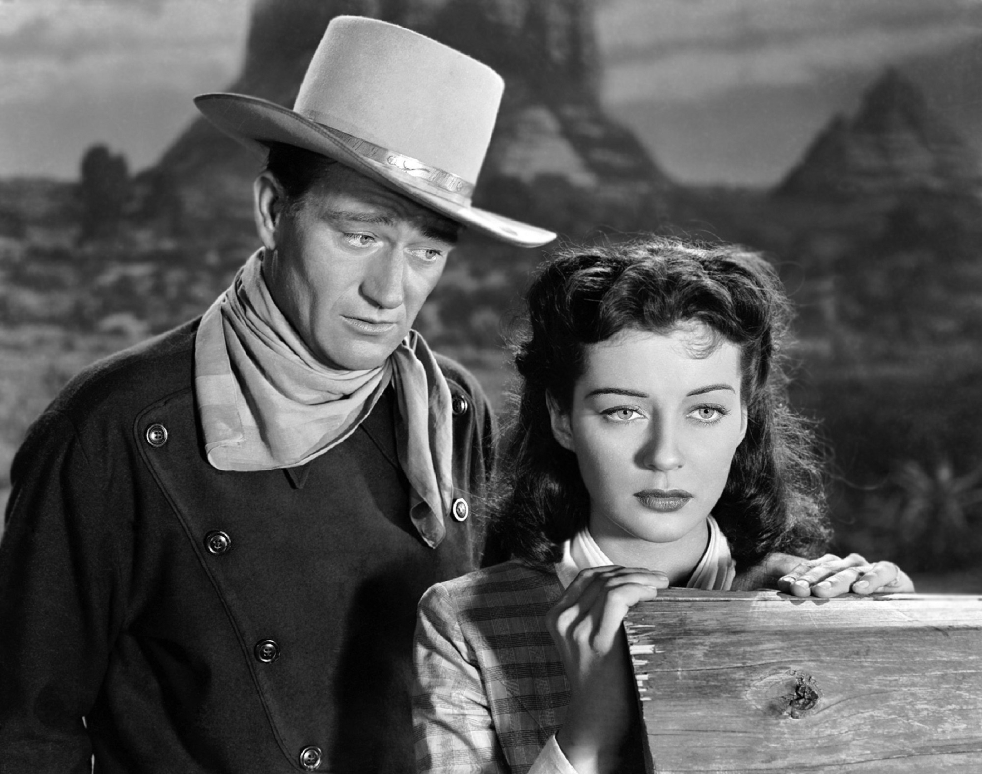 cowboy standing beside woman movie still john wayne gail russell 2k