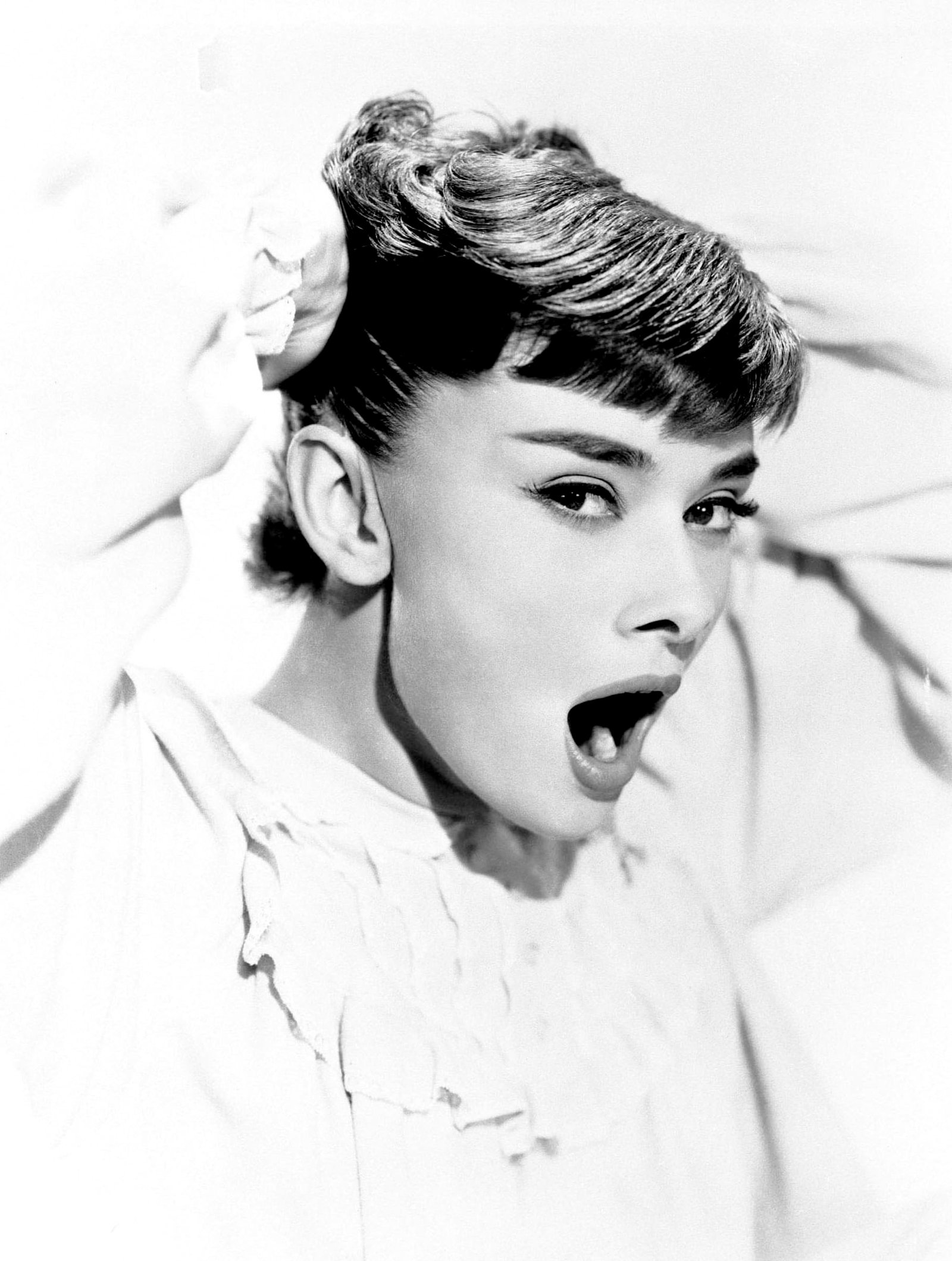 greyscale photo of woman wearing white shirt Audrey Hepburn