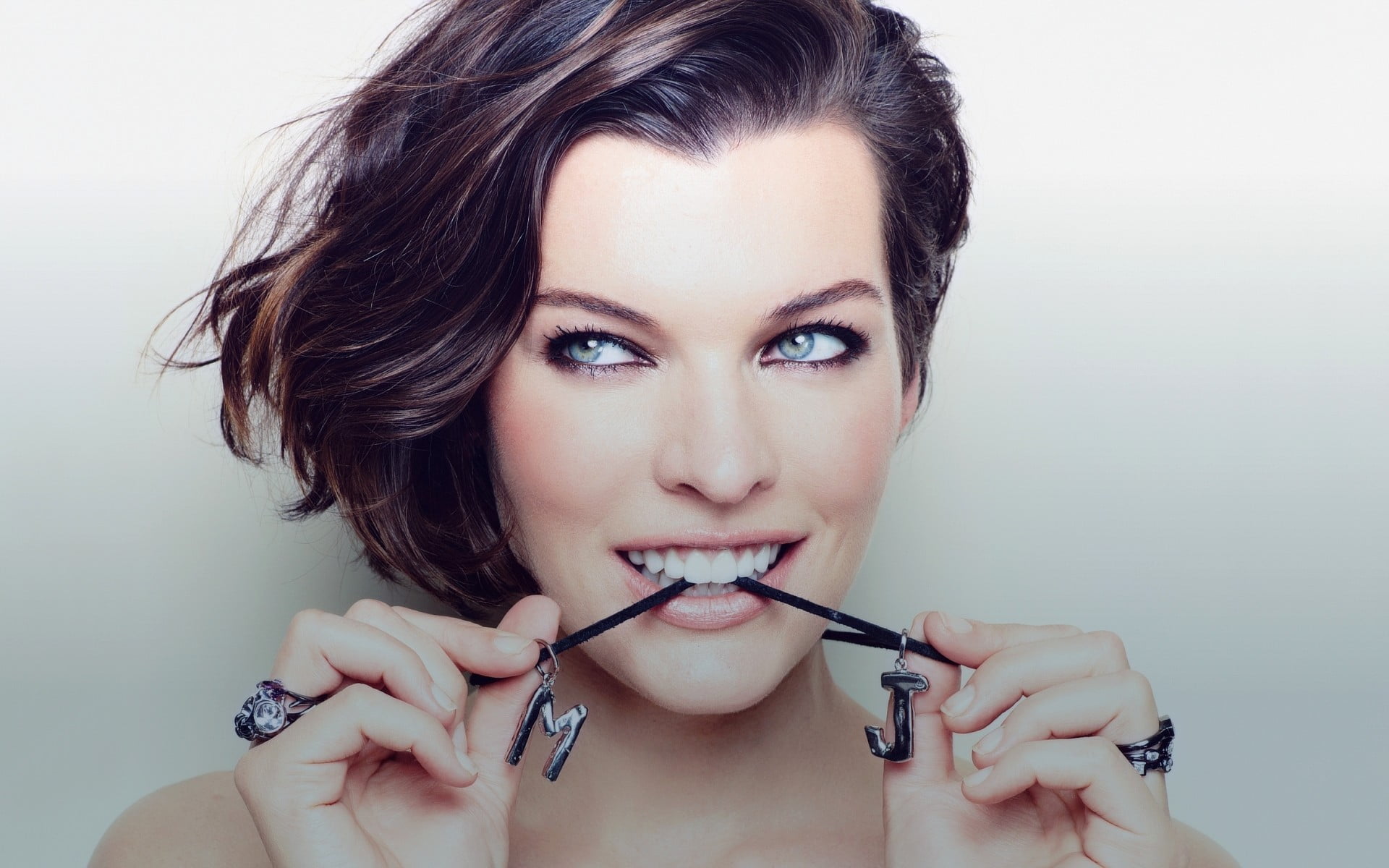 Milla Jovovich face smiling biting women actress looking away
