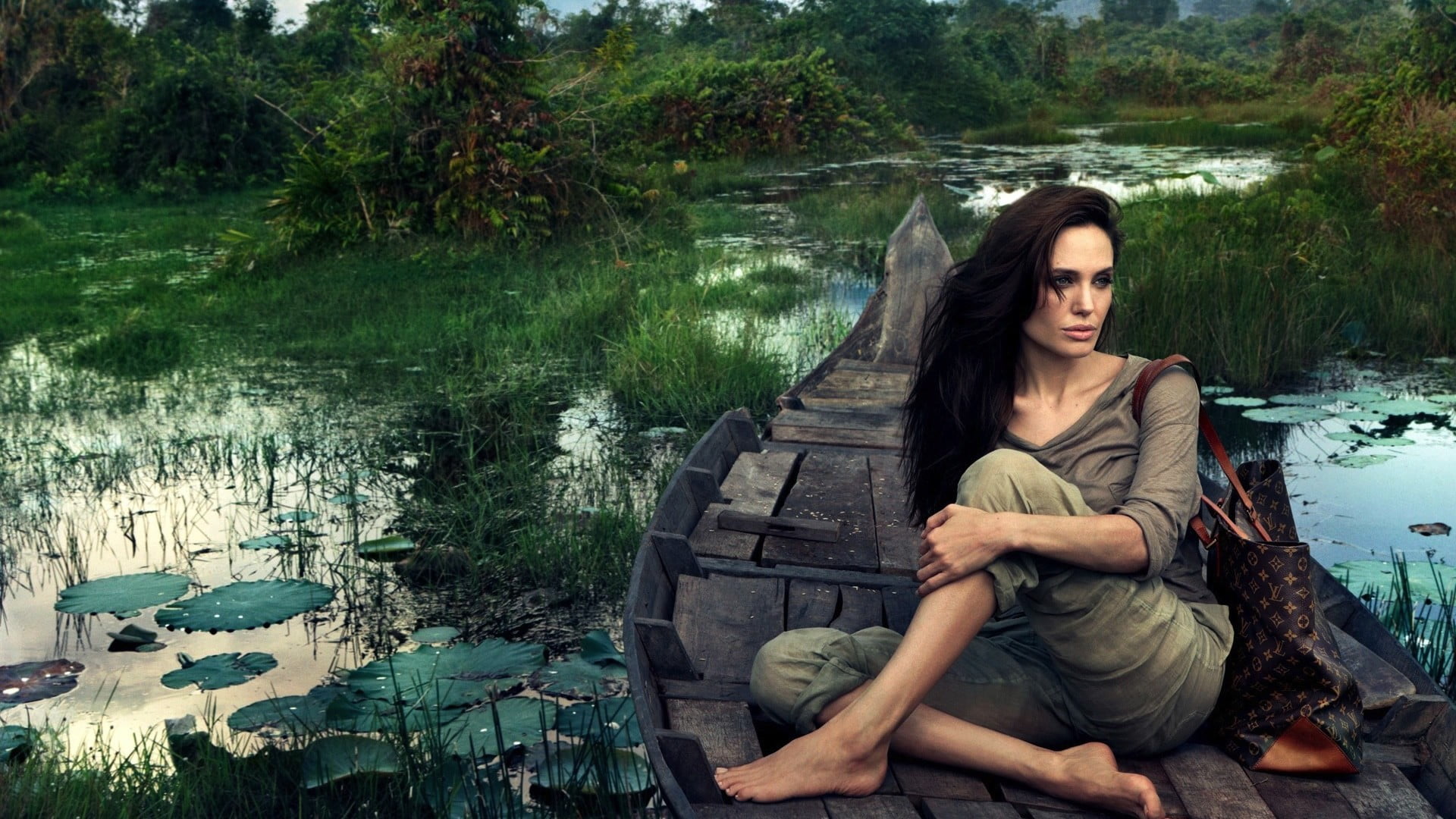 woman sitting on boat painting women model celebrity Angelina Jolie