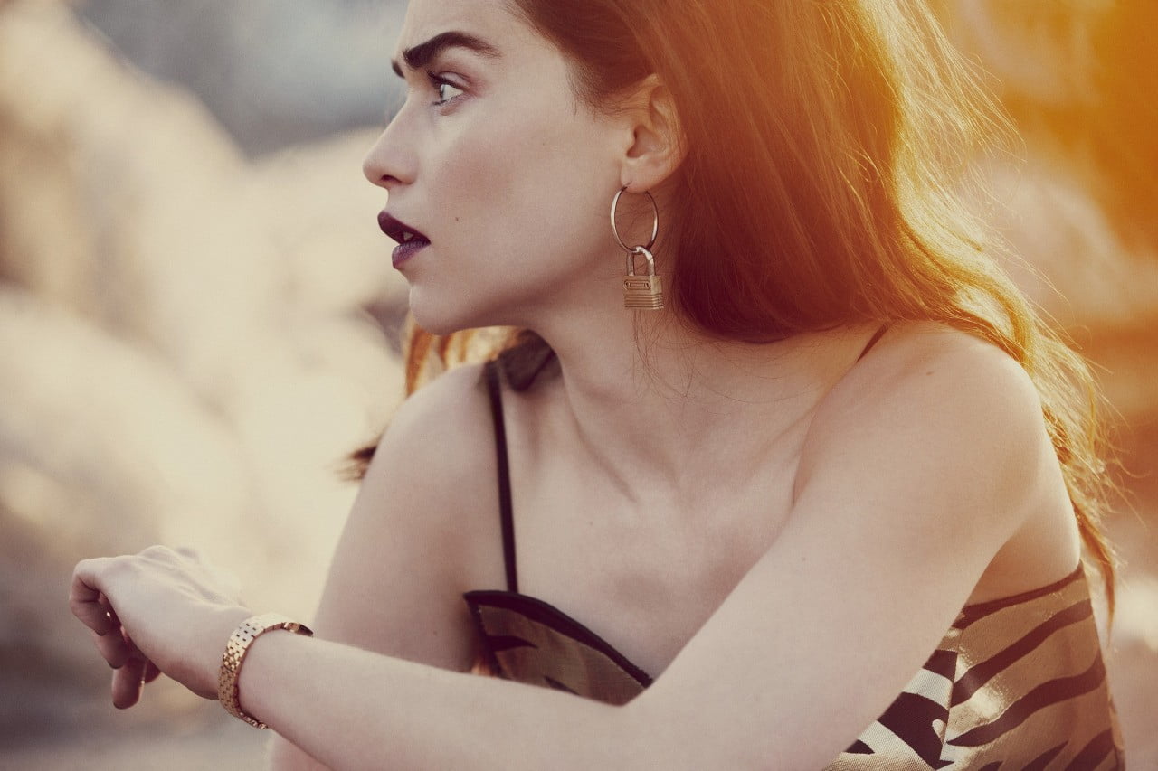 woman wearing black and gold zebra print spaghetti strap looking at her right side