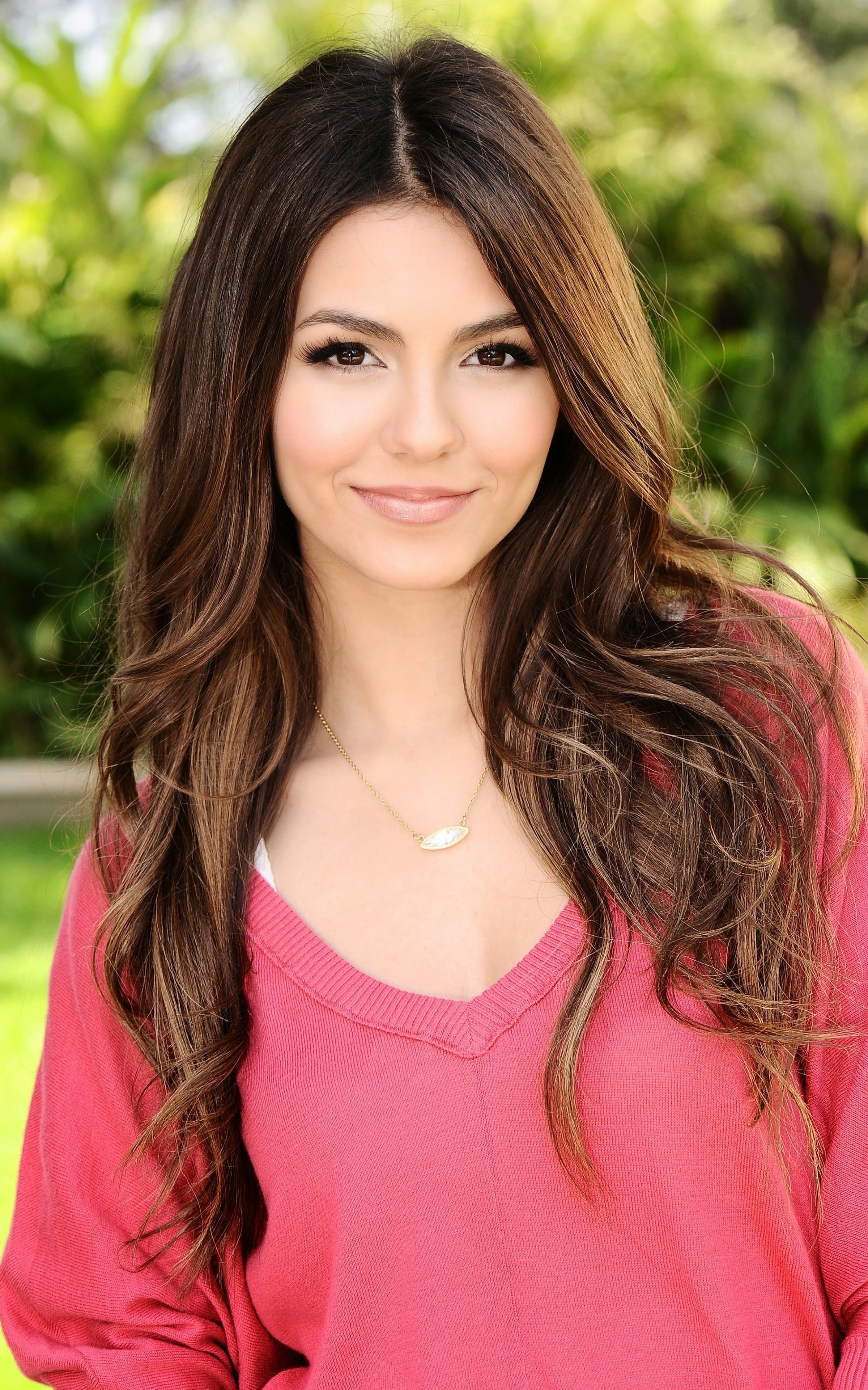 woman wearing silver colored pendant necklace and pink v neck sweatshirt 2k