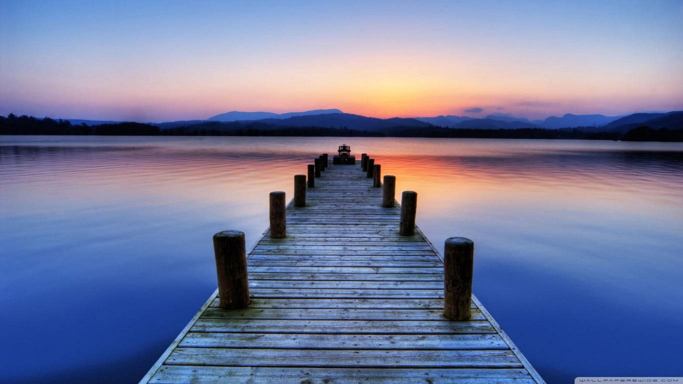 brown wood ocean dock under sunset pier lake nature landscape