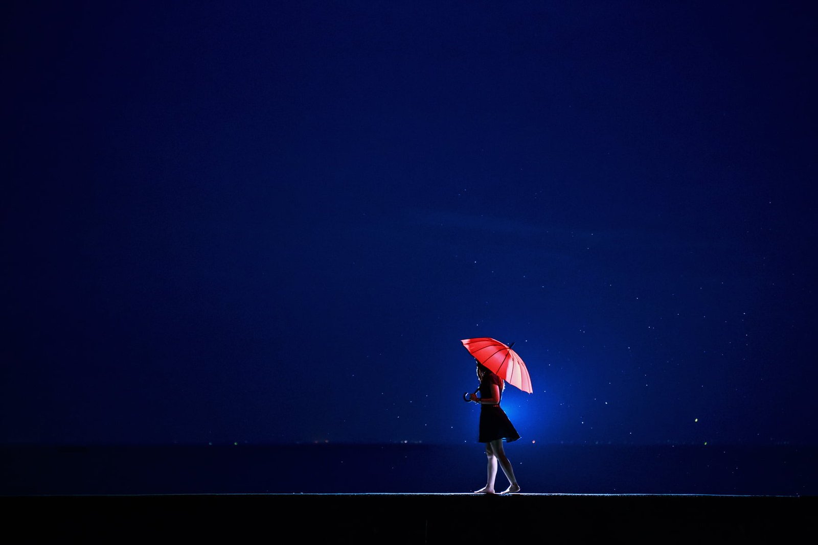 woman in black dress holding red umbrella nature landscape 2k