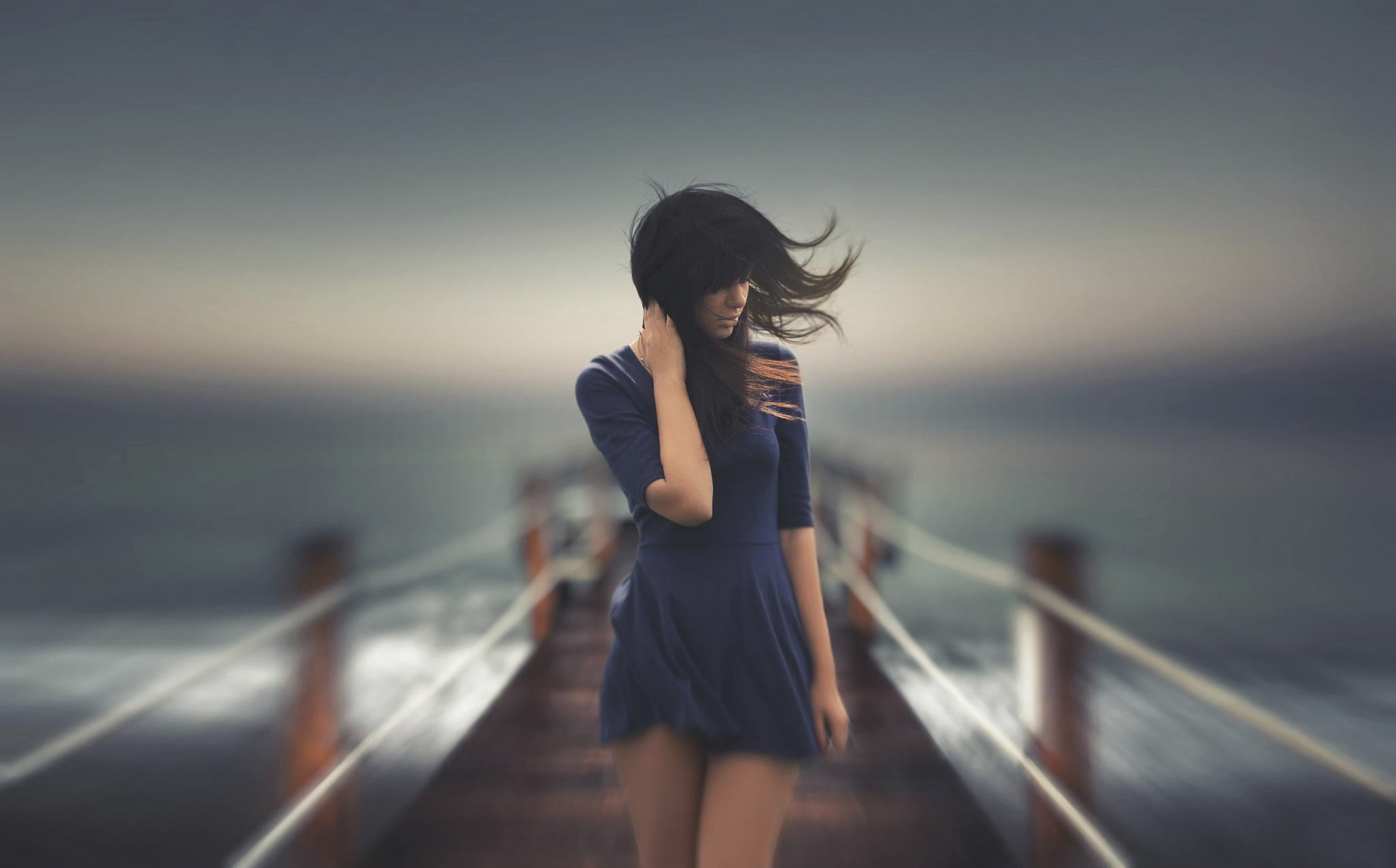 women's black mini dress timelapse photograph of woman walking on dock 2k