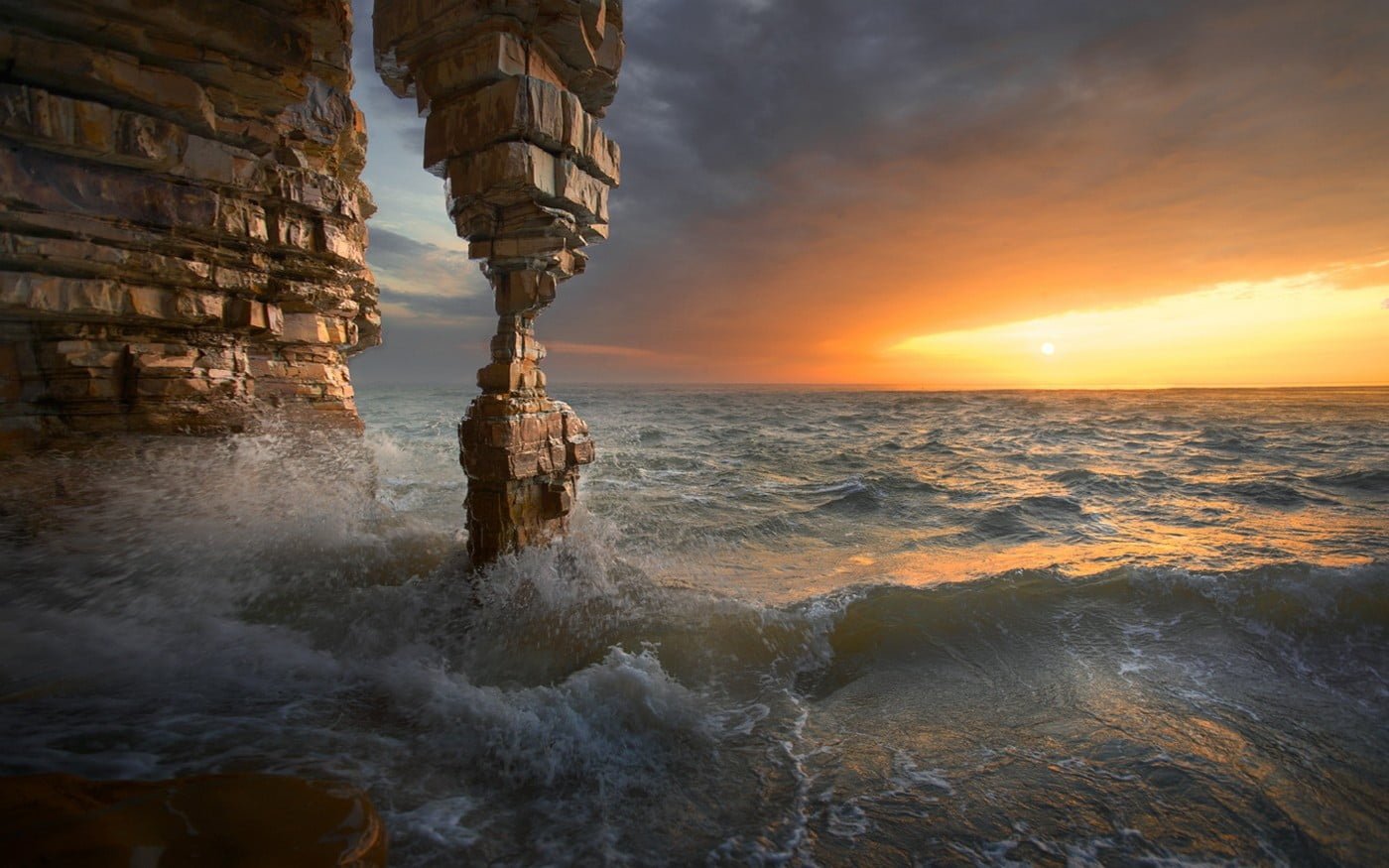 body of water nature landscape sunset sea rock cave erosion