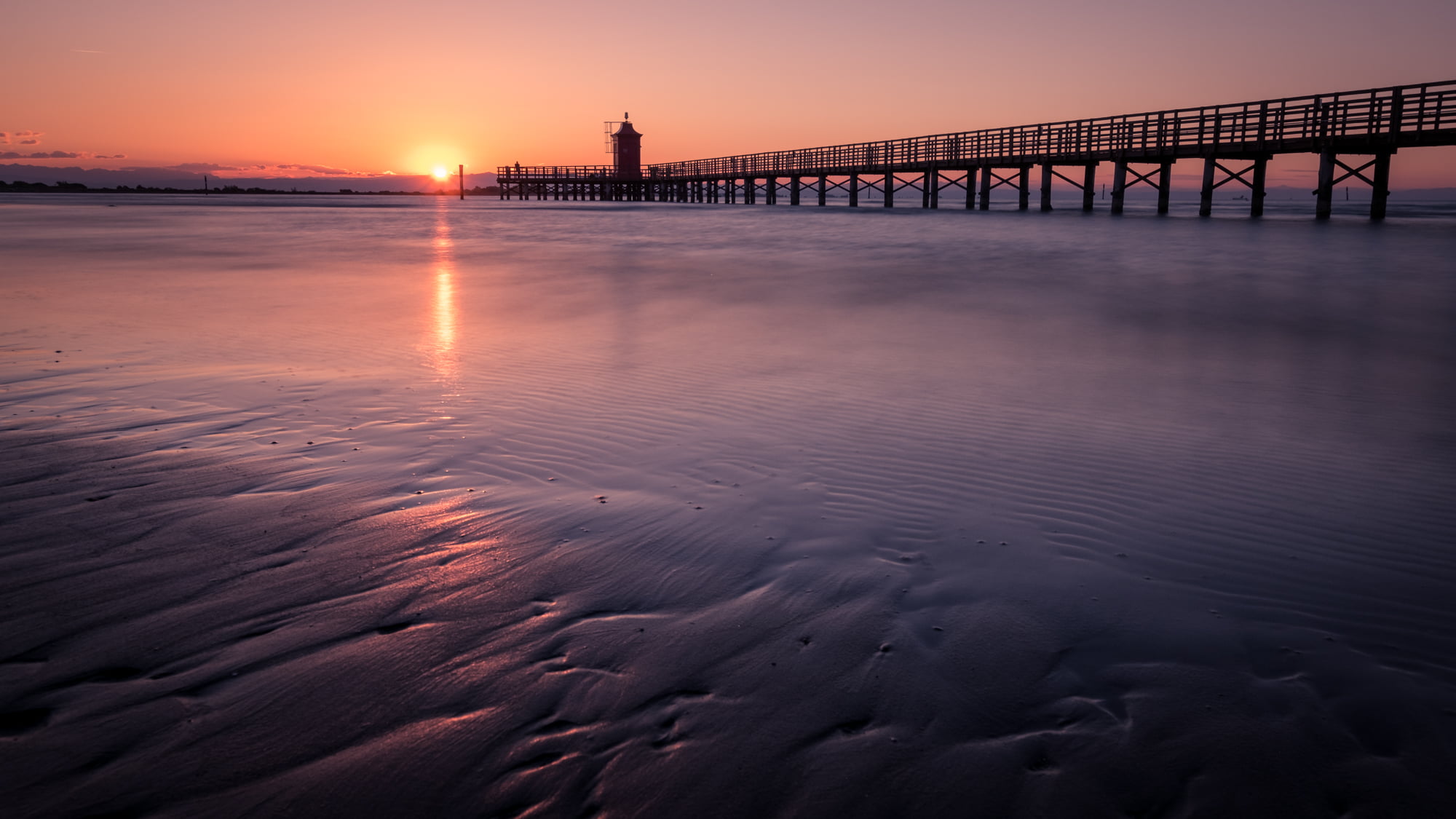 calm water near dock bridge during golden hour lignano sabbiadoro italy 2k