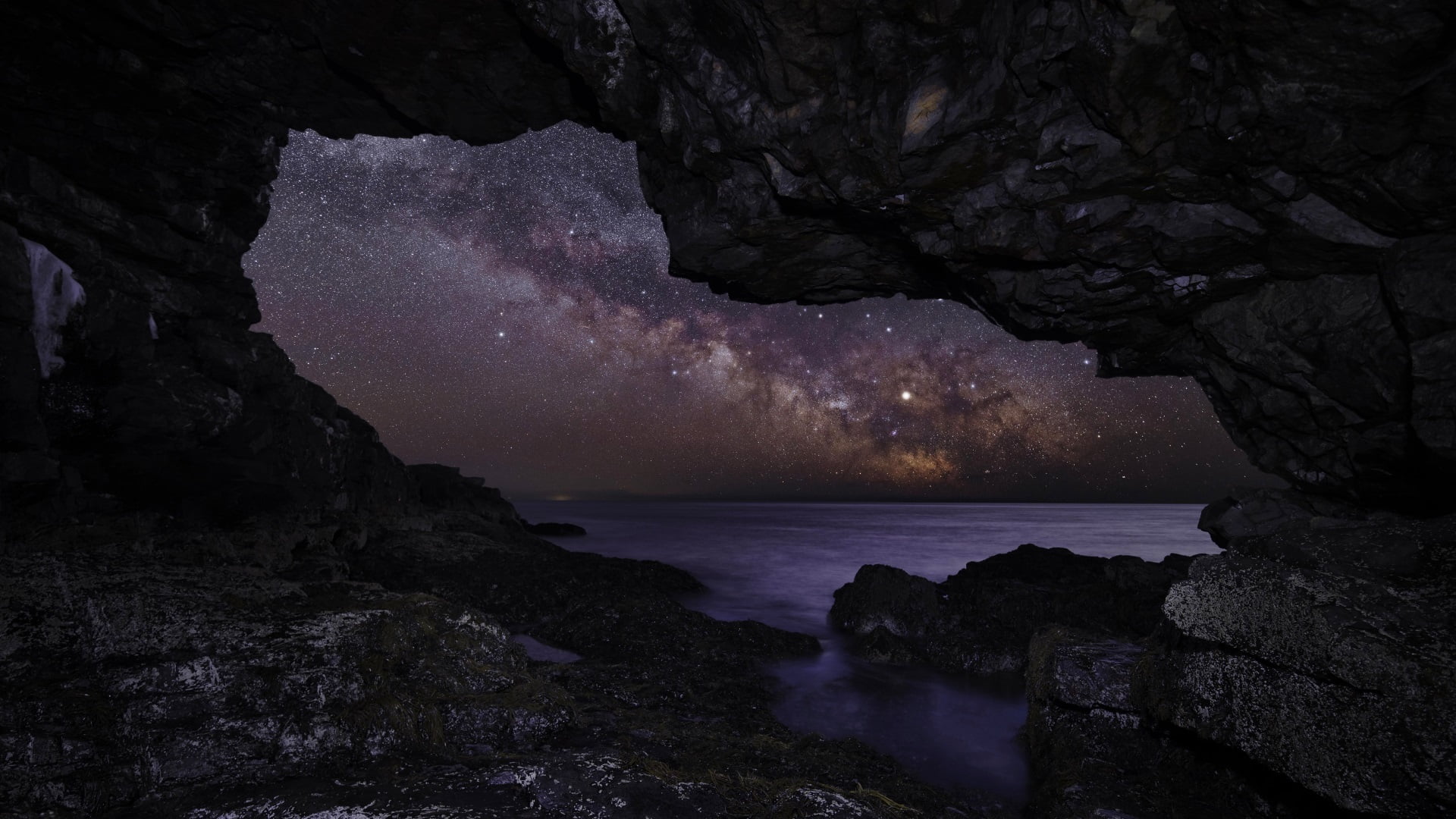 cave beside water wallpaper nature night stars Milky Way 2k