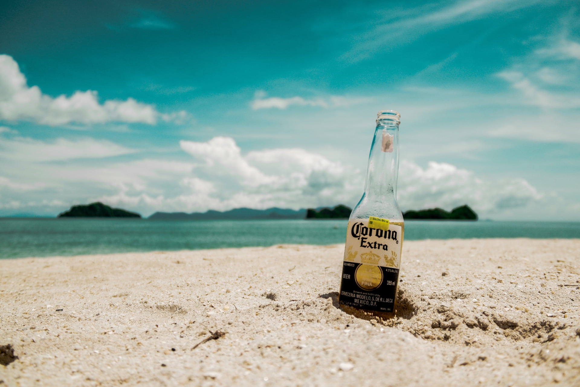 Corona Extra beer bottle on beach shore focus photography near 2k