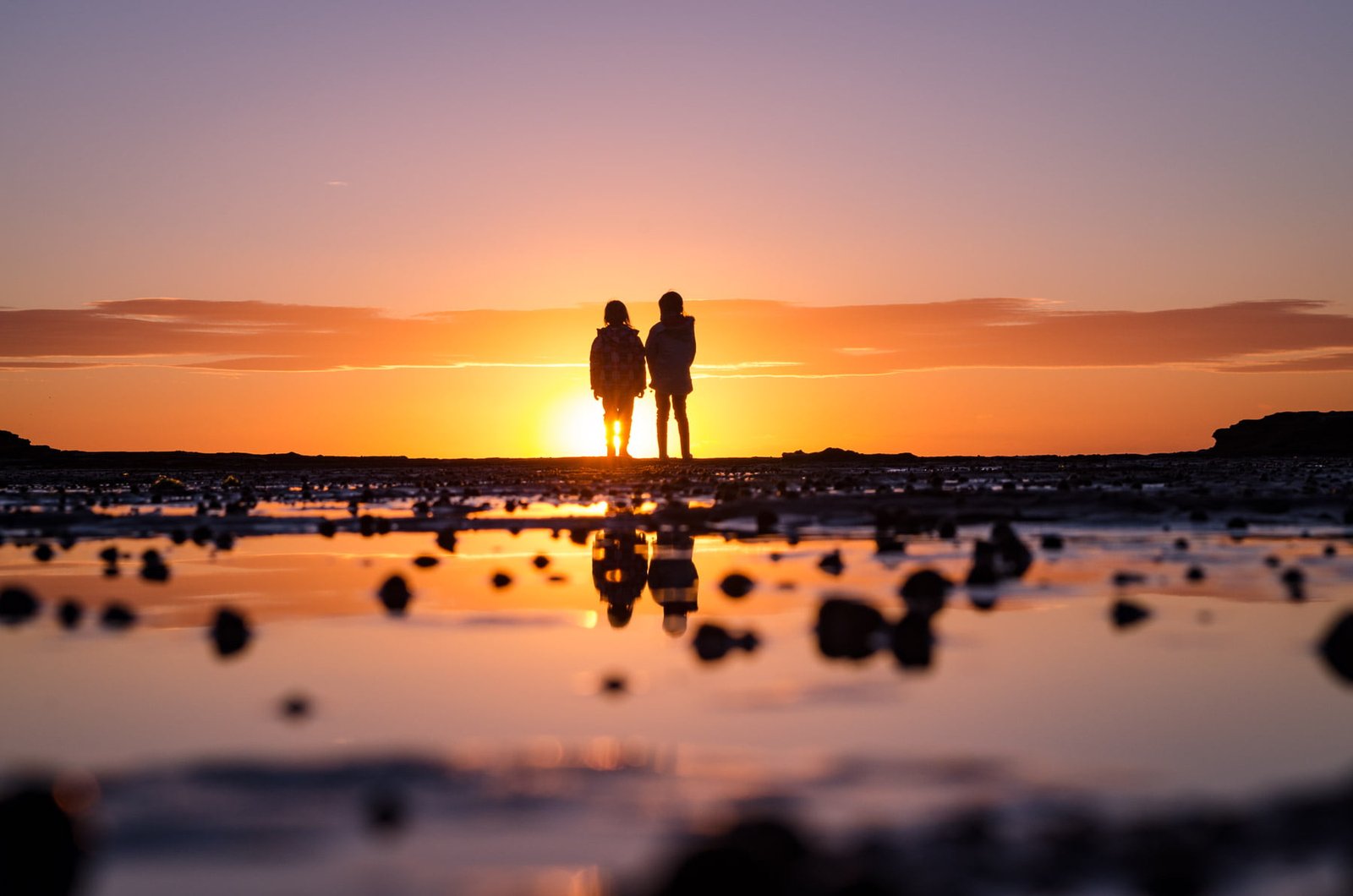 silhouette of couple during sunset North Era coast track 2k
