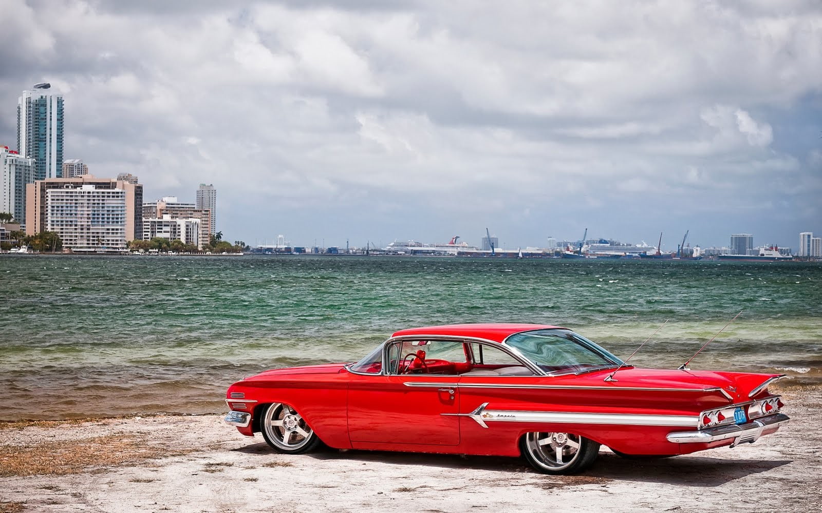 car Chevrolet Impala sea beach sky cloud building exterior 2k