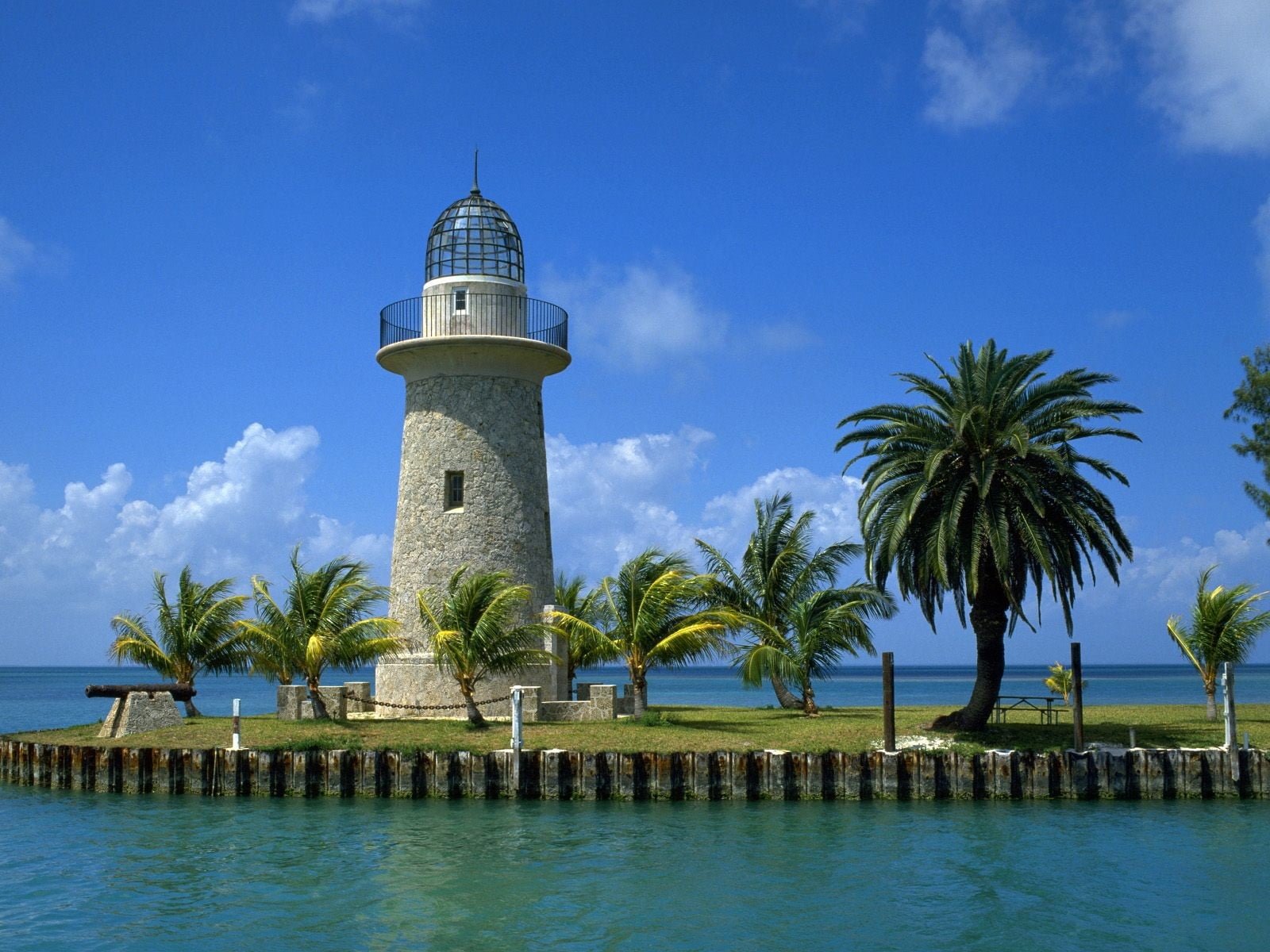 gray concrete lightouse clouds beach lighthouse palm trees 2k