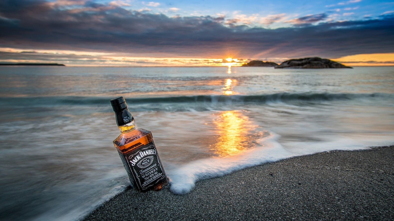 Jack Daniel's liquor bottle nature landscape sea coast bottles 2k