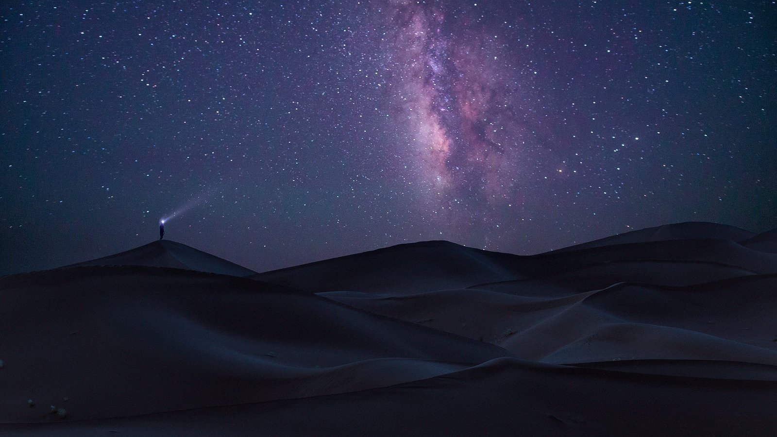 man standing on sand dunes at night digital wallpaper nature 2k