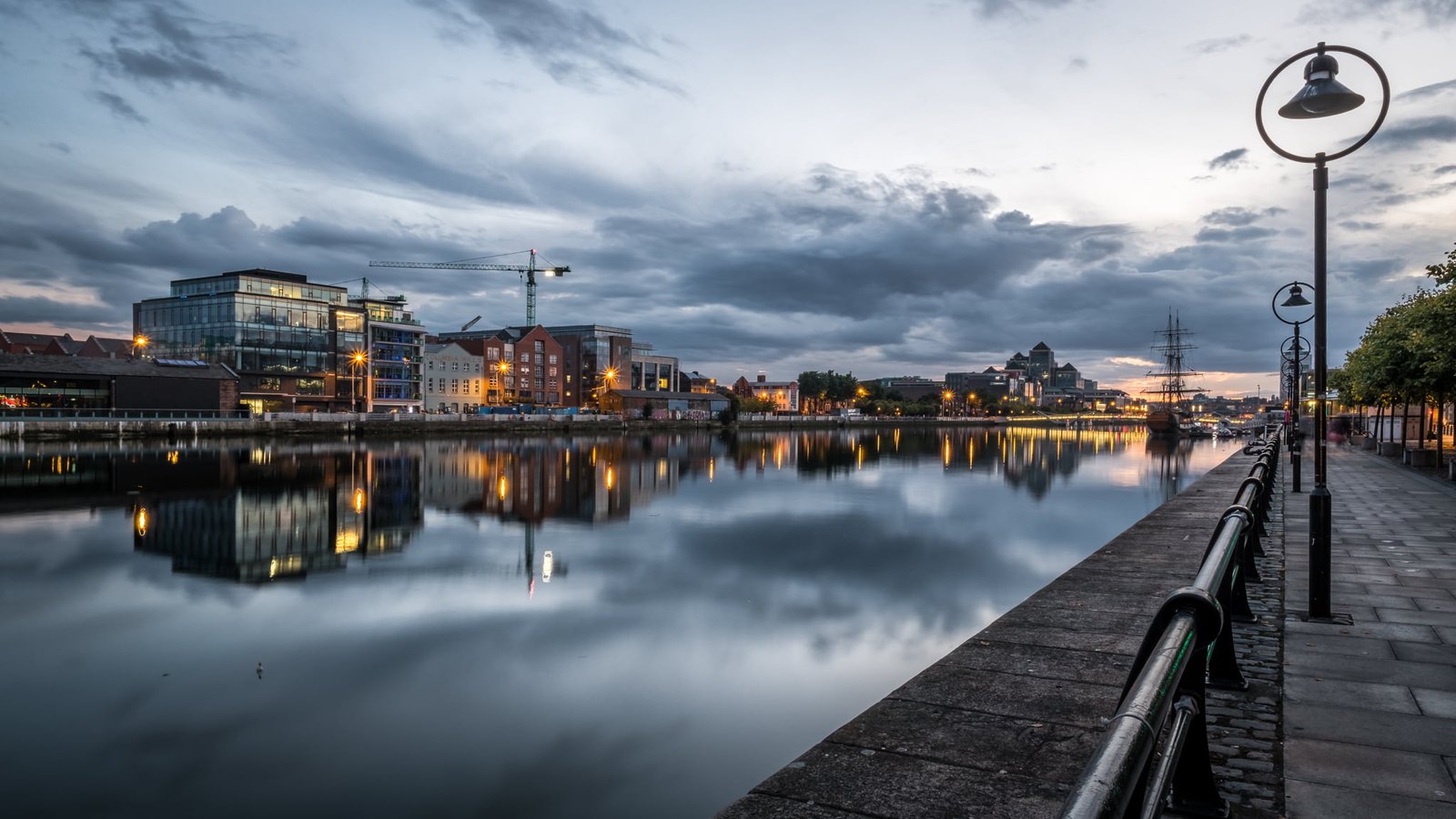 photo of medium rise buildings near body water dublin ireland 2k