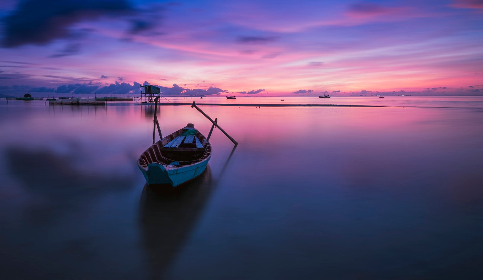 photography of gray canoe on body water under purple sky during daytime vietnam 2k 4k