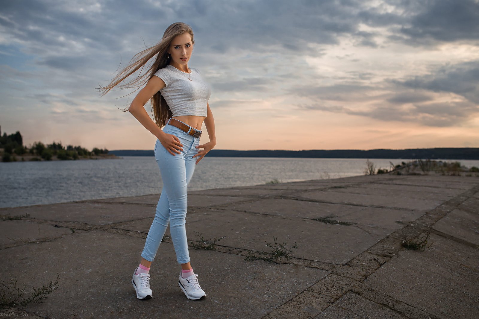 women's white short sleeved crop top women outdoors jeans legs crossed 2k