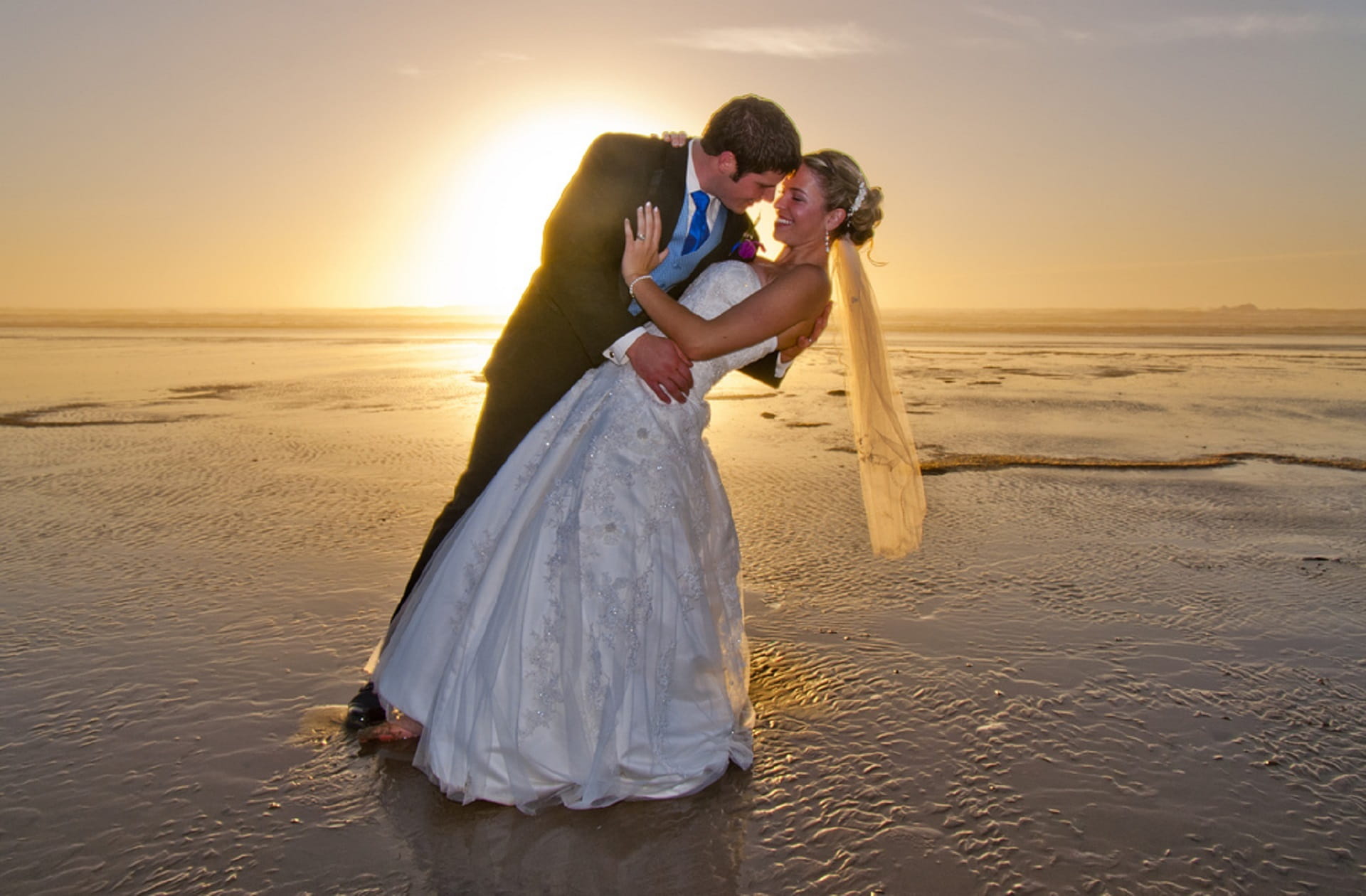man and woman wearing wedding dresses standing on body of water 2k