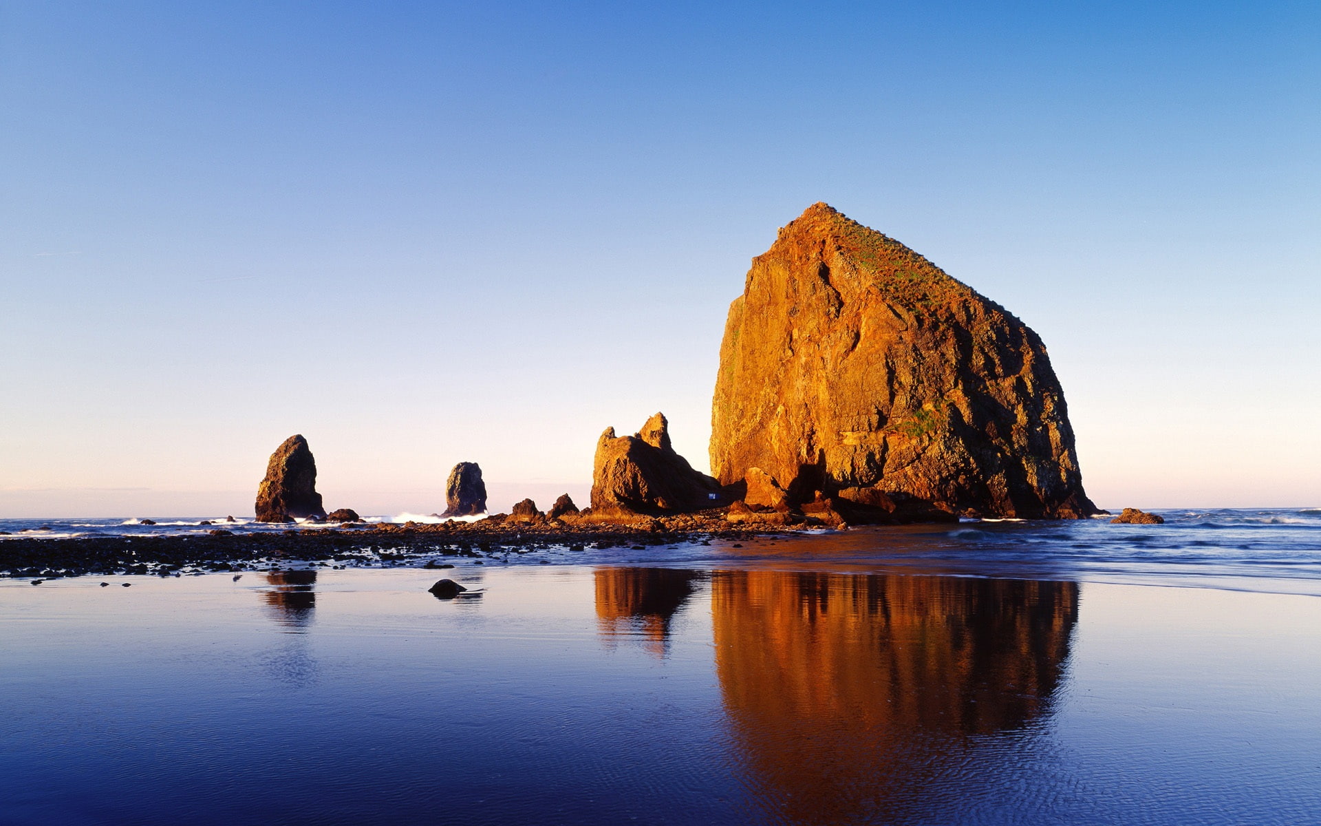 Cannon Beach Oregon USA brown rock formation on body of water 2k