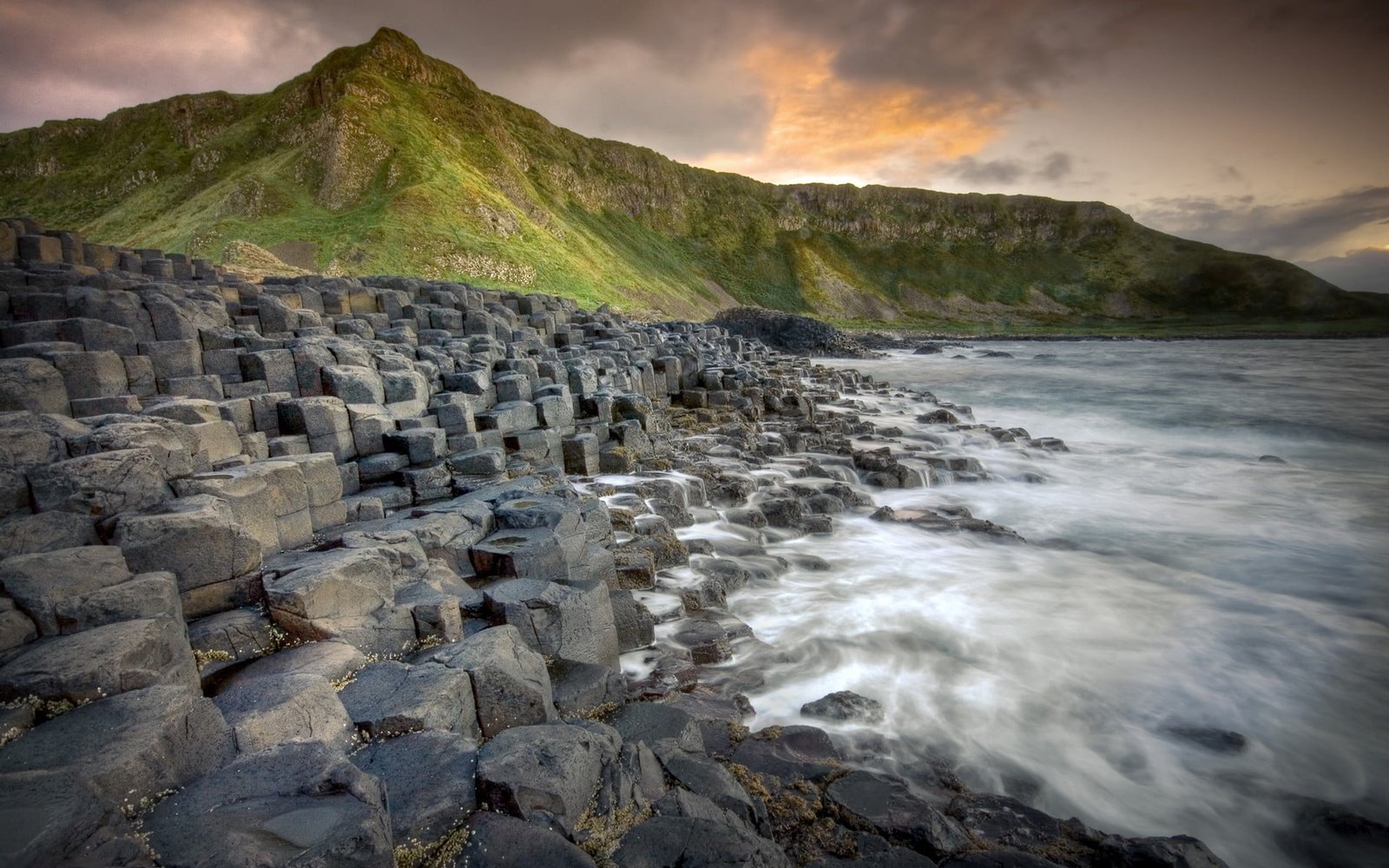 gray concrete beside ocean near mountain at daytime nature landscape 2k