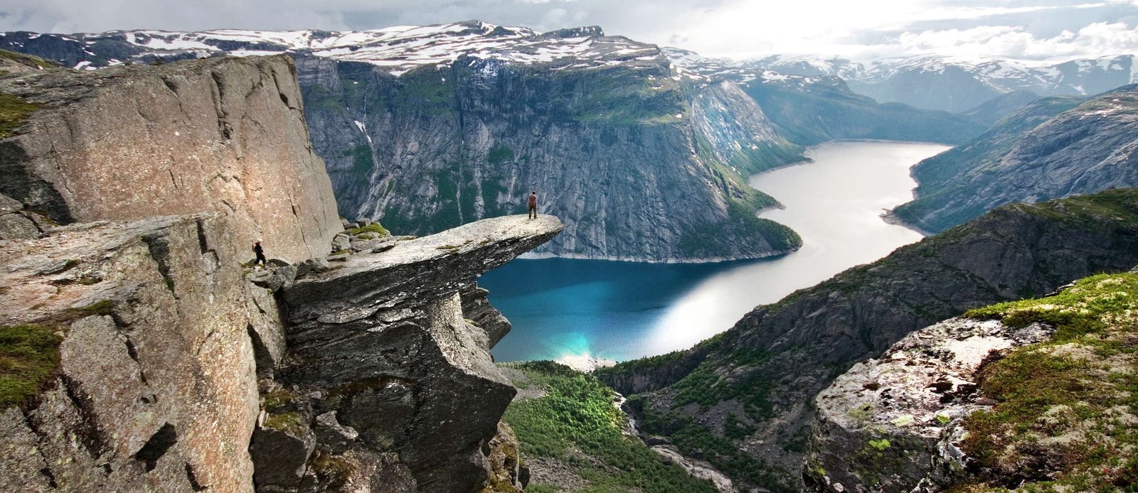 rock mountain cliff fjord sea canyon snow clouds Norway 2k