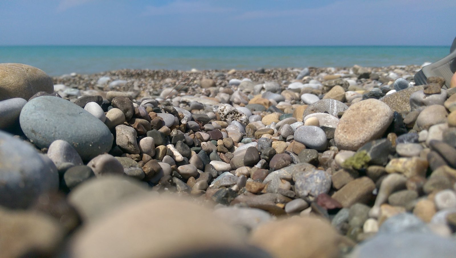 beach stones sea horizon land solid rock water stone object 2k